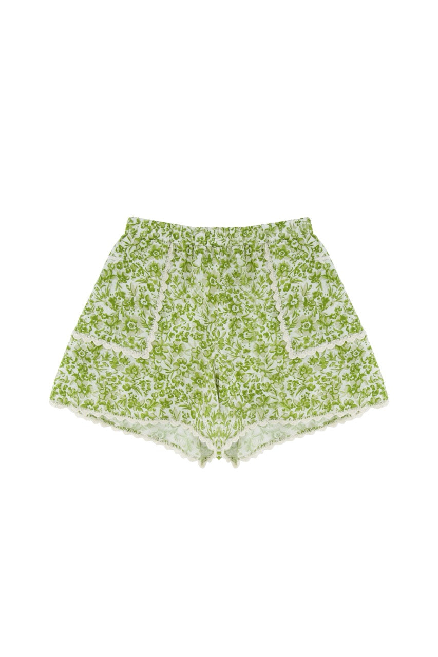Green floral shorts on a white background