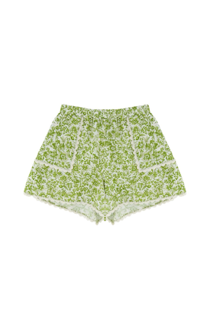 Green floral shorts on a white background