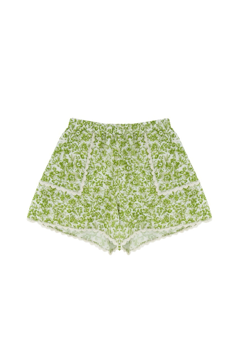 Green floral shorts on a white background