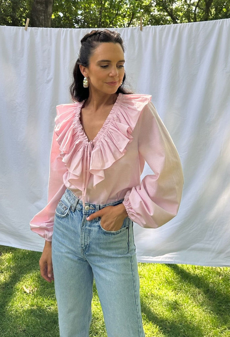 Regina pink ruffled long sleeved blouse with jeans