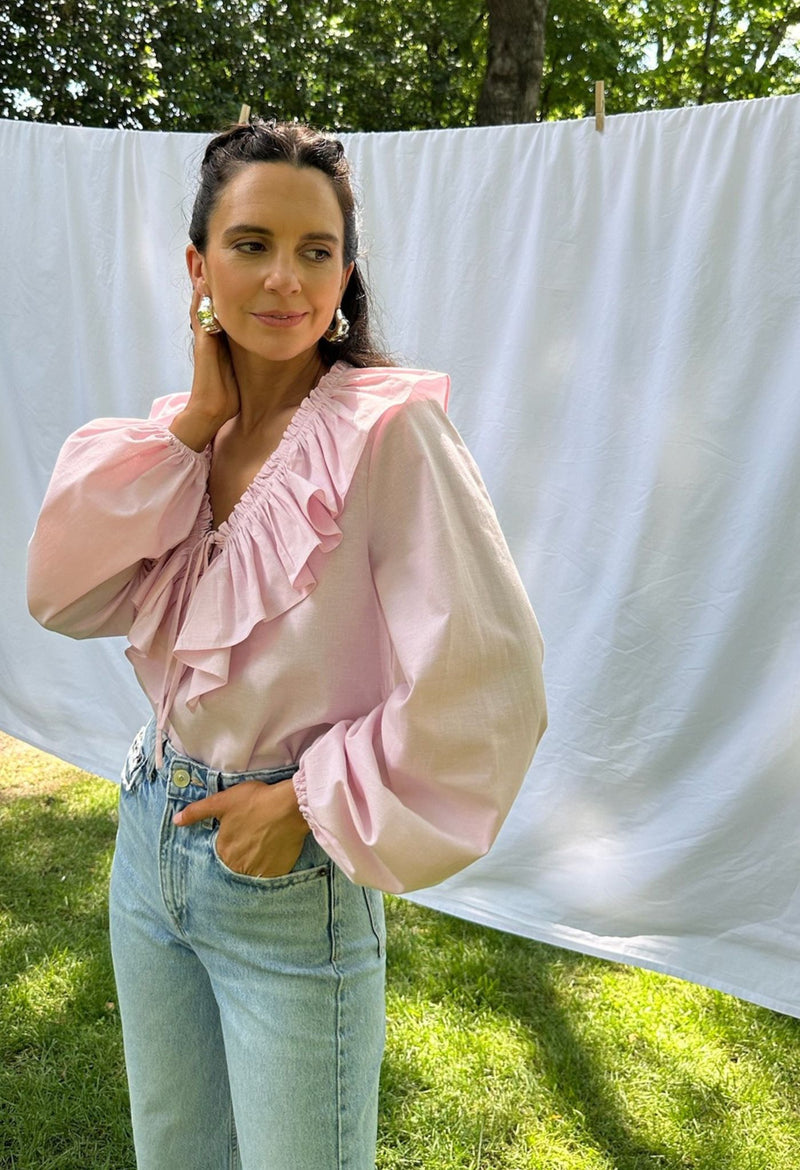 Regina pink ruffled long sleeved blouse with jeans