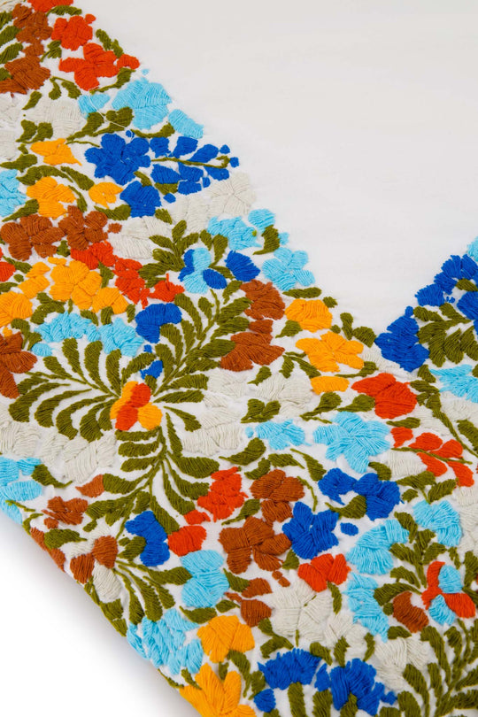 The Wrap Skirt in White emboidered with multicolor flores detail